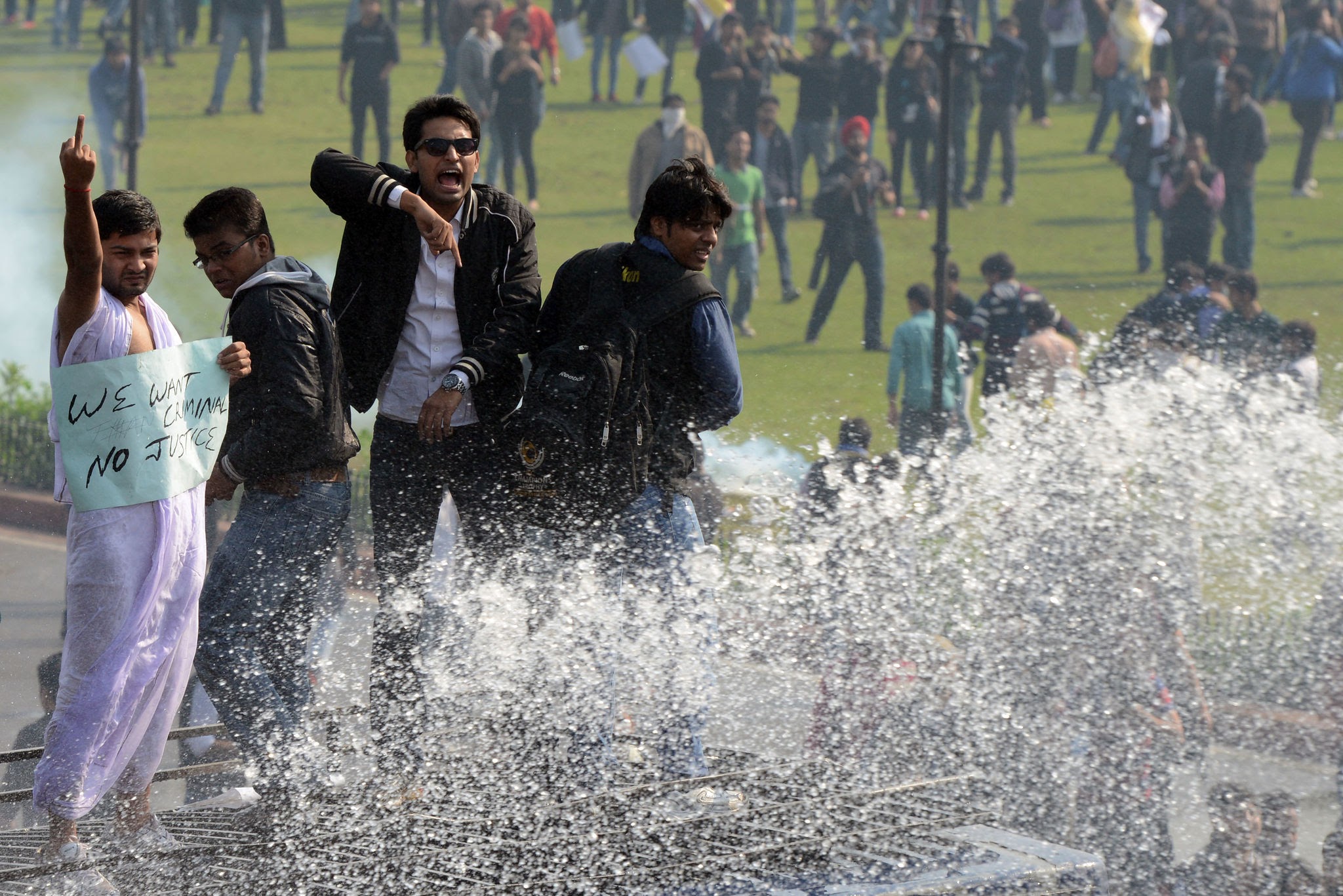 Student protesters facing police water cannons near Parliament Street