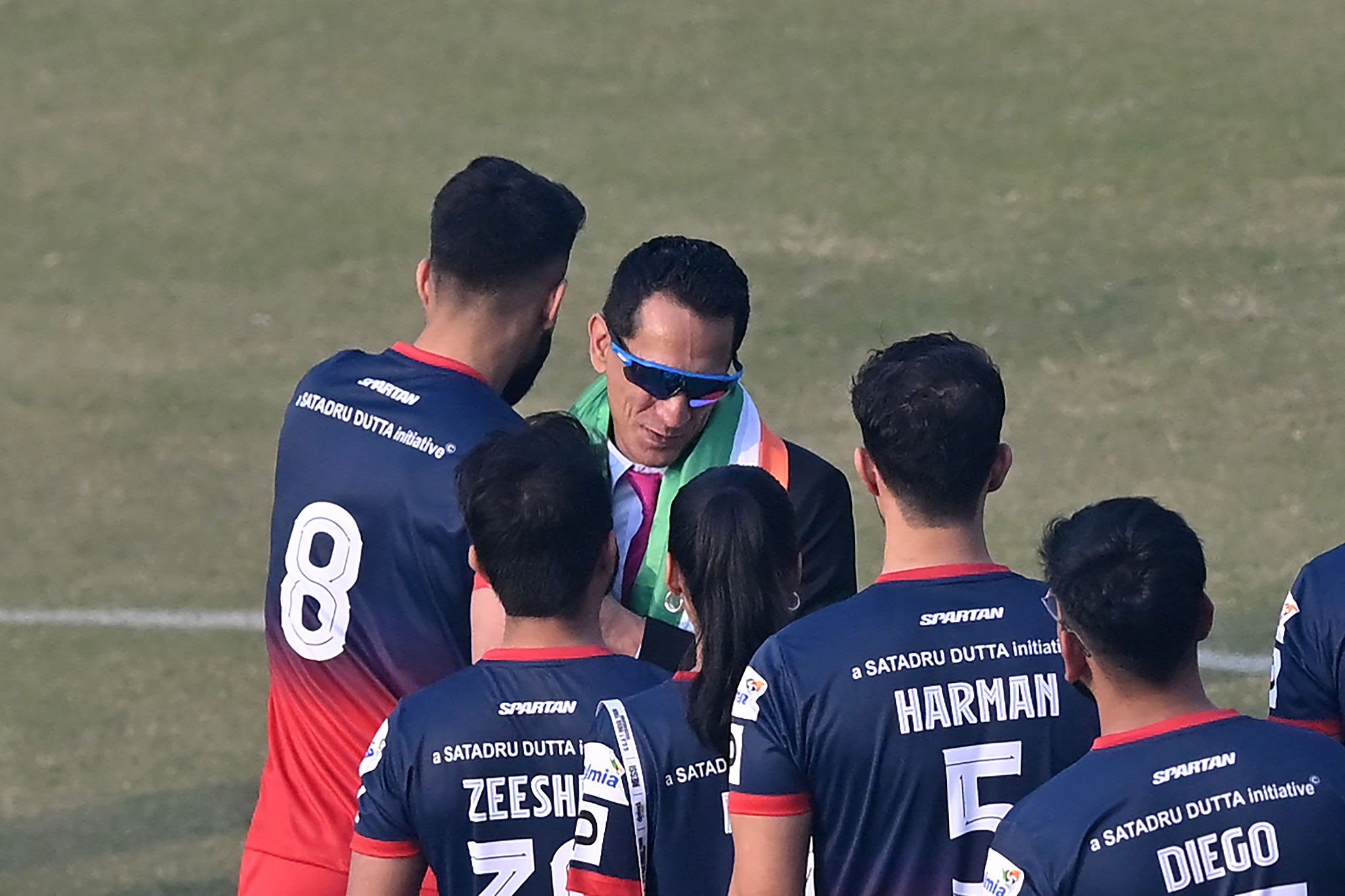 Ranjit Bajaj with Minerva Academy footballers on the match pitch