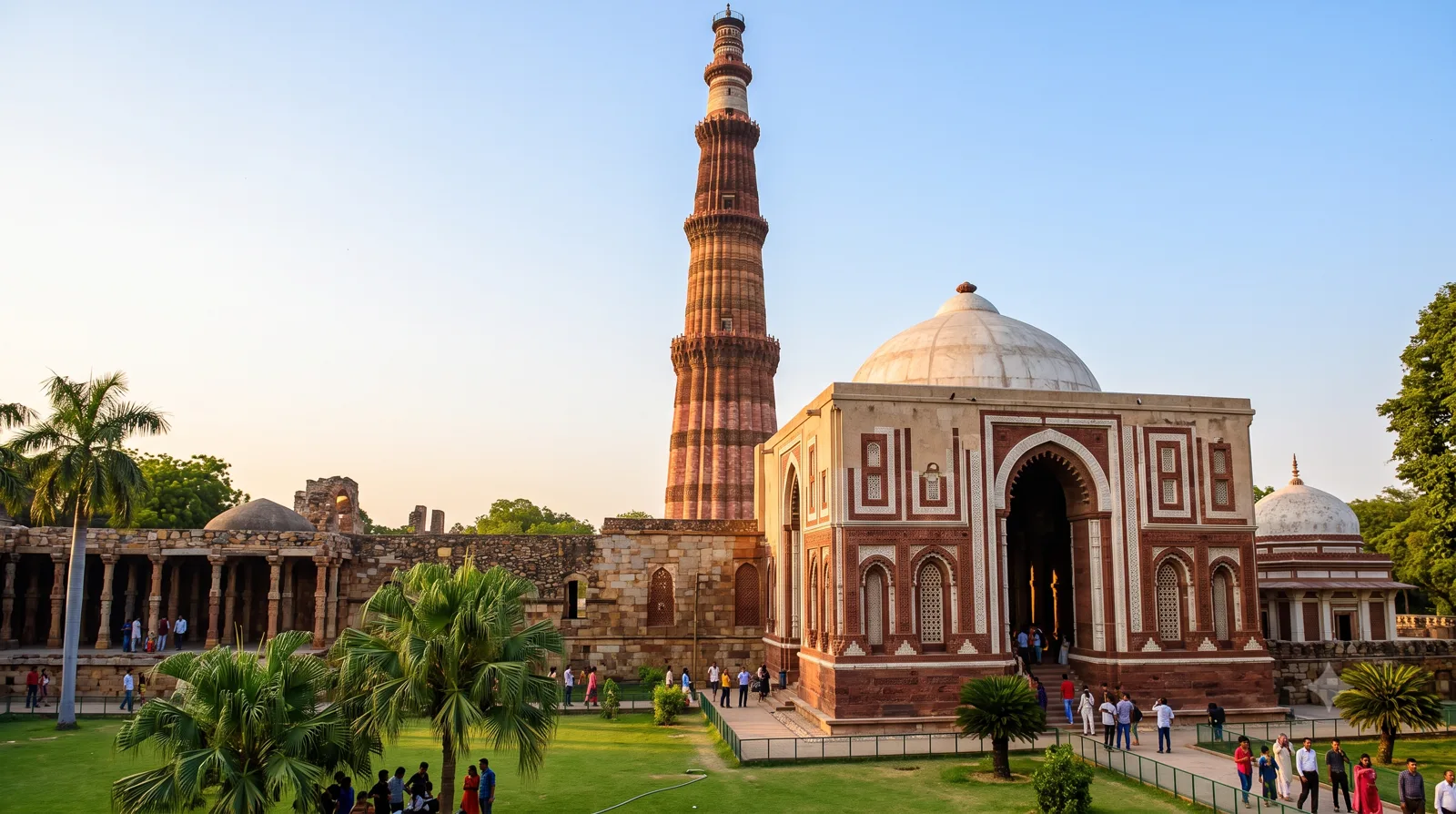 A photograph of the Qutub Minar complex displaying Indo-Islamic architecture with its distinctive towering minaret and domed structures