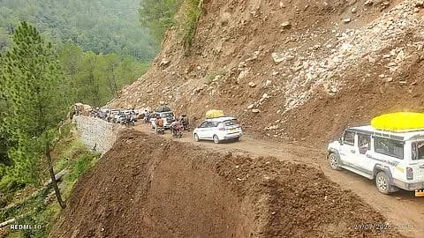 Vehicles stranded due to a massive landslide blocking a mountain highway in Uttarakhand