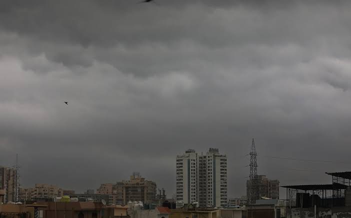 Dark monsoon cloud cover looming over Kolkata city buildings