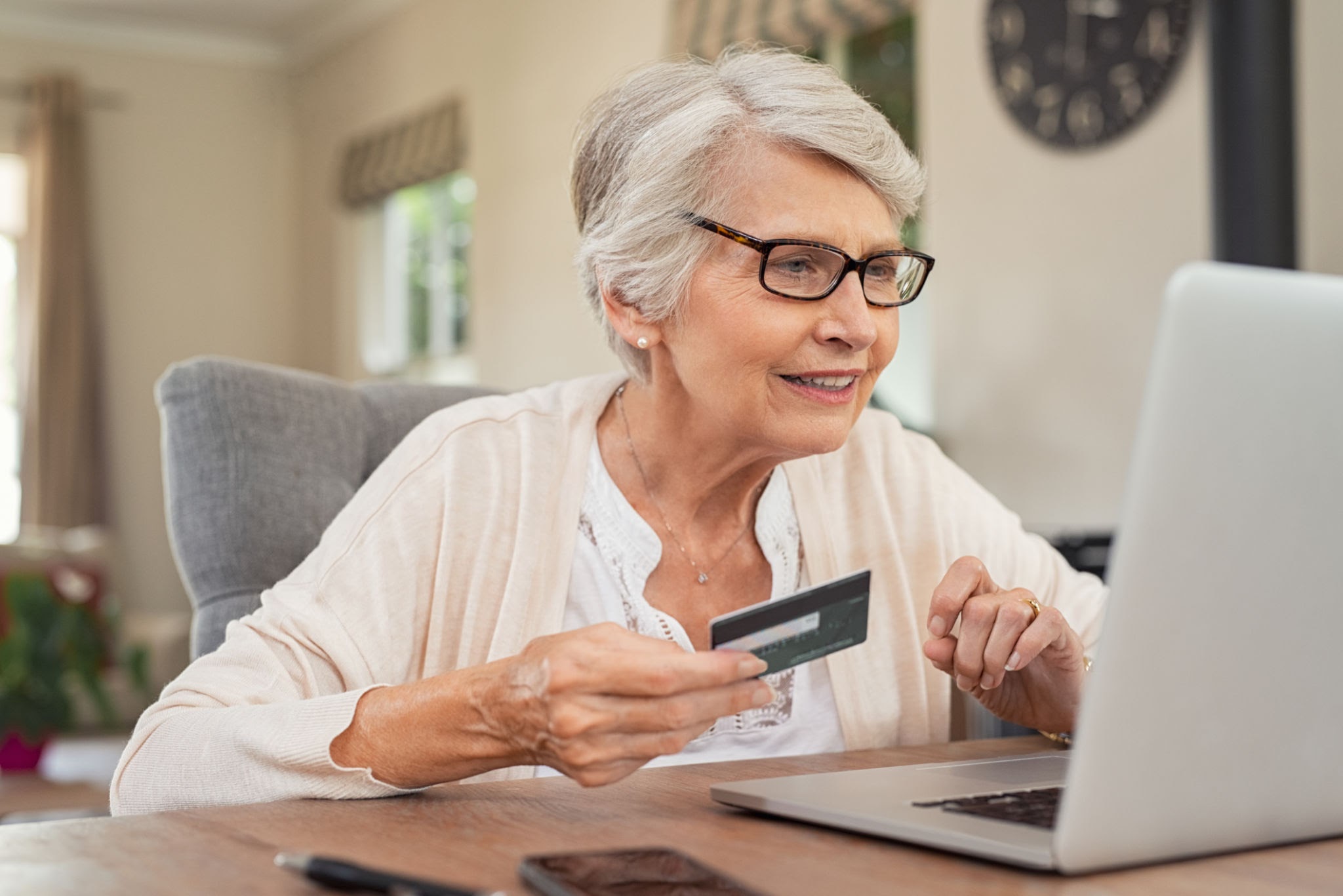 Senior citizen pensioner accessing digital e-Pension portal comfortably from home