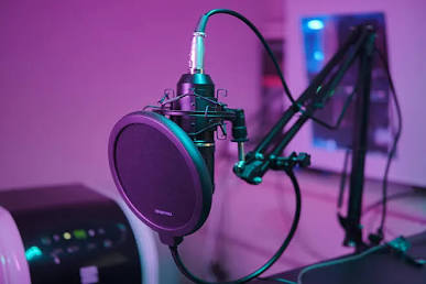 Recording condenser microphone in purple studio lighting