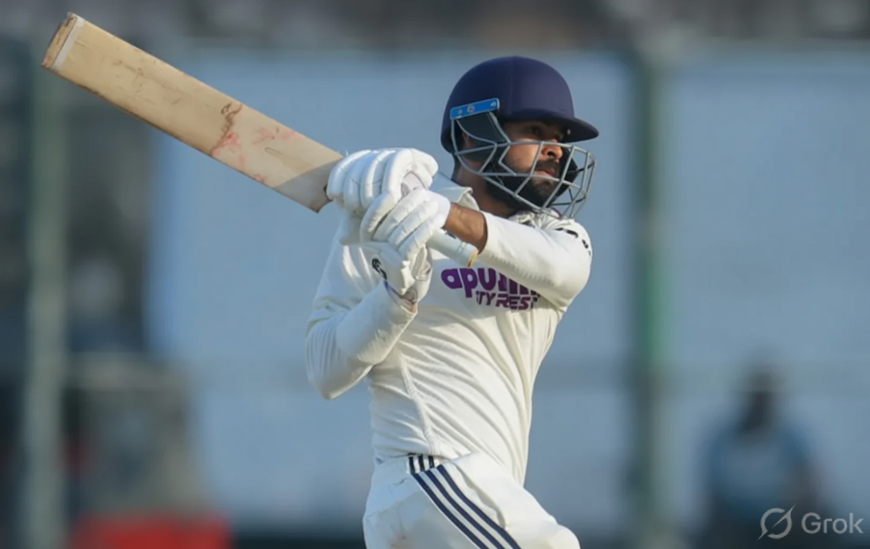 Saransh Jain playing a batting shot in white Test match kit