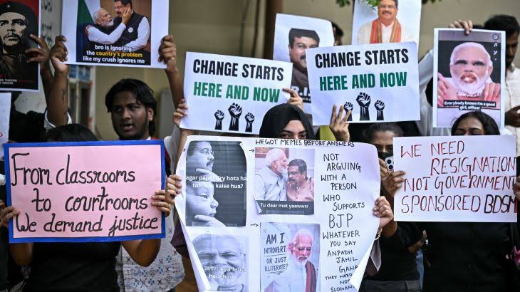 Student protesters holding placards demanding exam justice