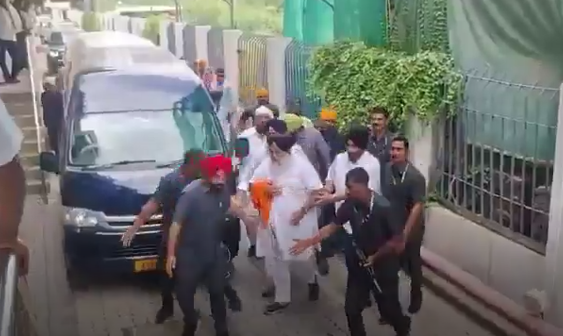 Sukhbir Singh Badal escorted by security personnel following the attack in Nanded