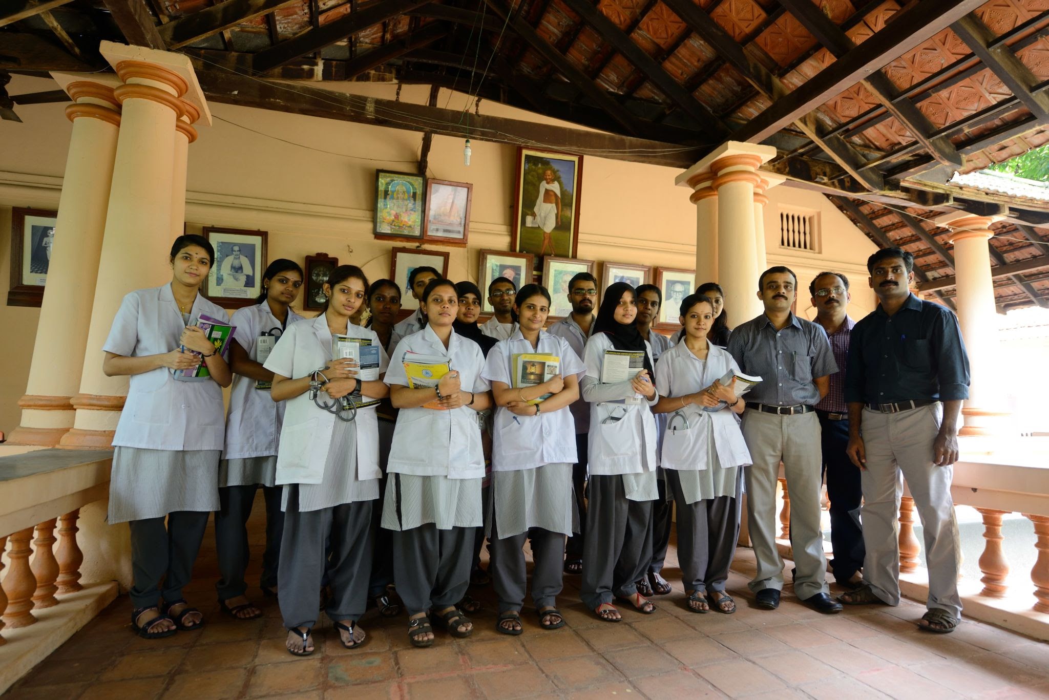 Group of BAMS medical students in white lab coats with stethoscopes standing at an Ayurvedic college campus