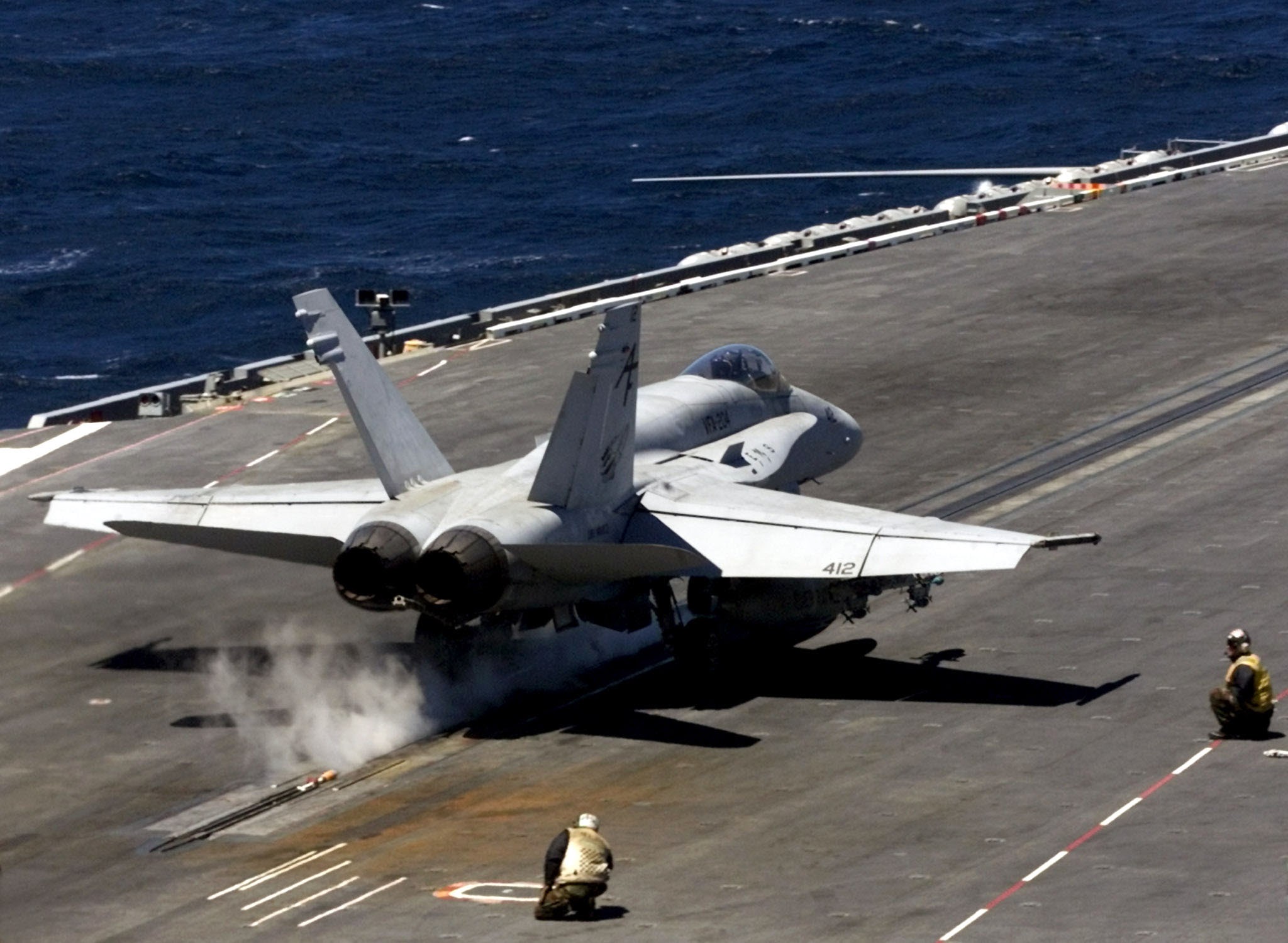 US Navy FA-18 Super Hornet launching via steam catapult off an aircraft carrier deck
