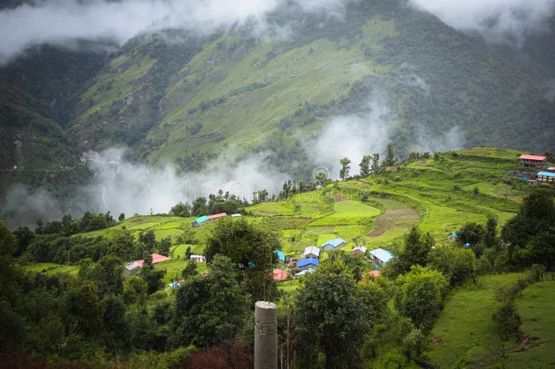 Scenic Indian mountain village surrounded by lush monsoon clouds