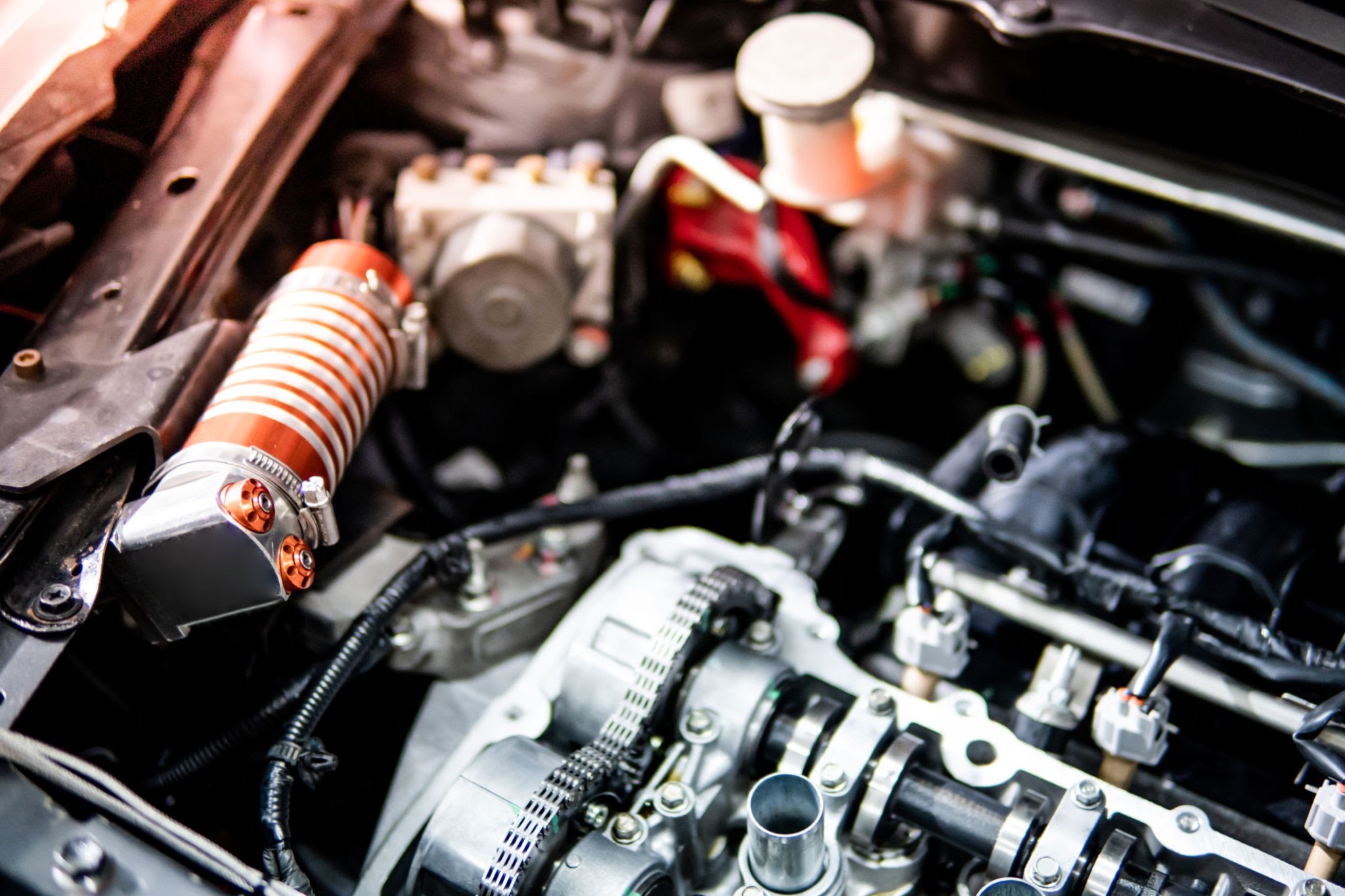 Close-up of car Internal Combustion Engine bay showing fuel injection lines and mechanical components
