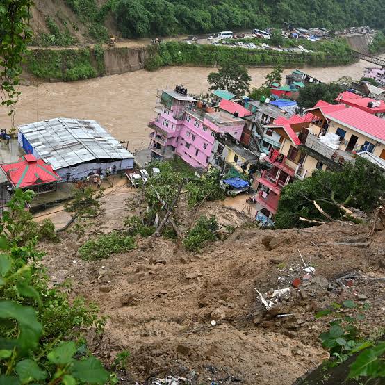 Massive mountain landslide washing away buildings near swollen river in Western Himalayas