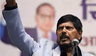 Union Minister Ramdas Athawale speaking at podium with raised arm